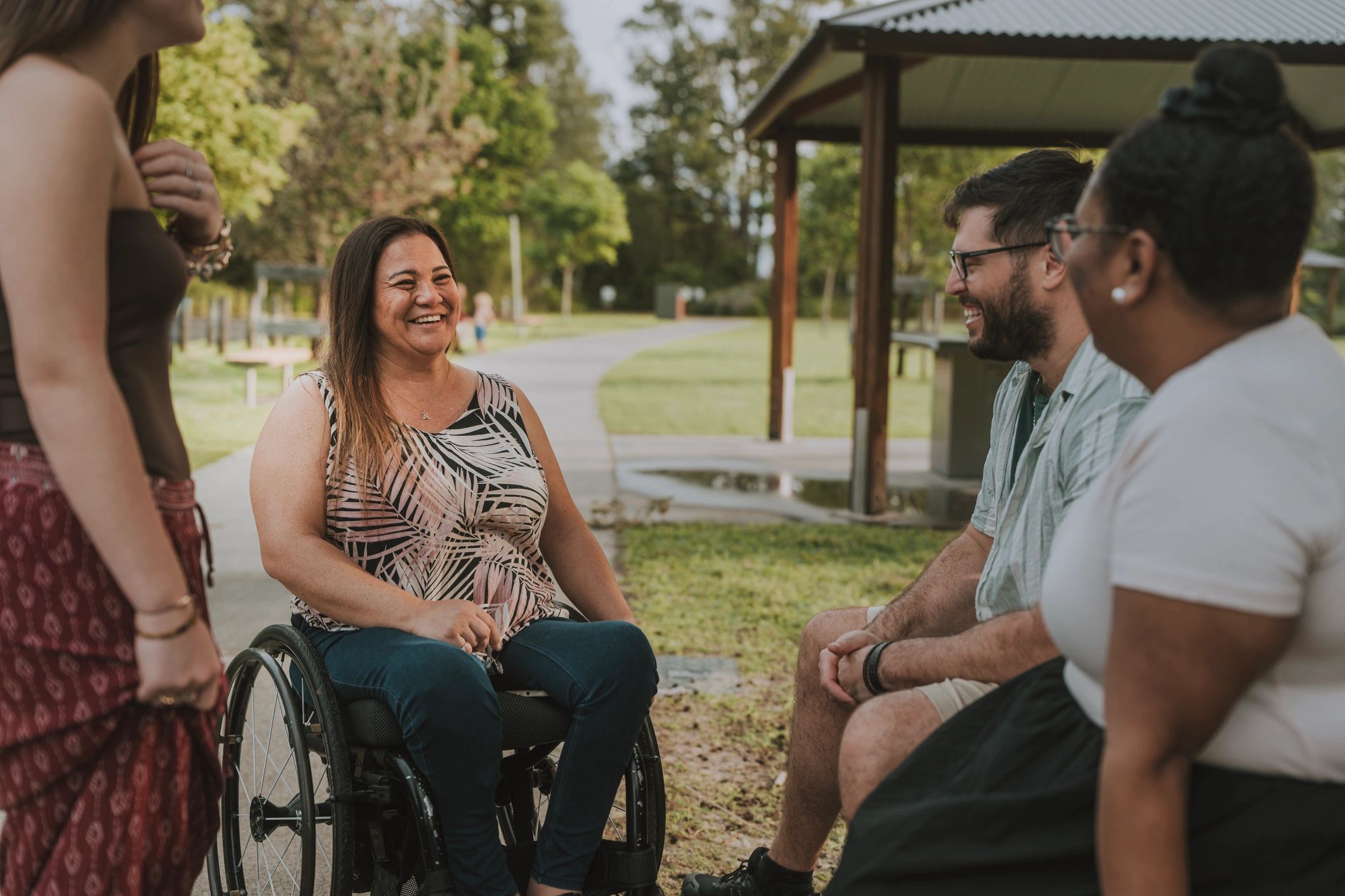 Inclusive group of friends talking together outdoors