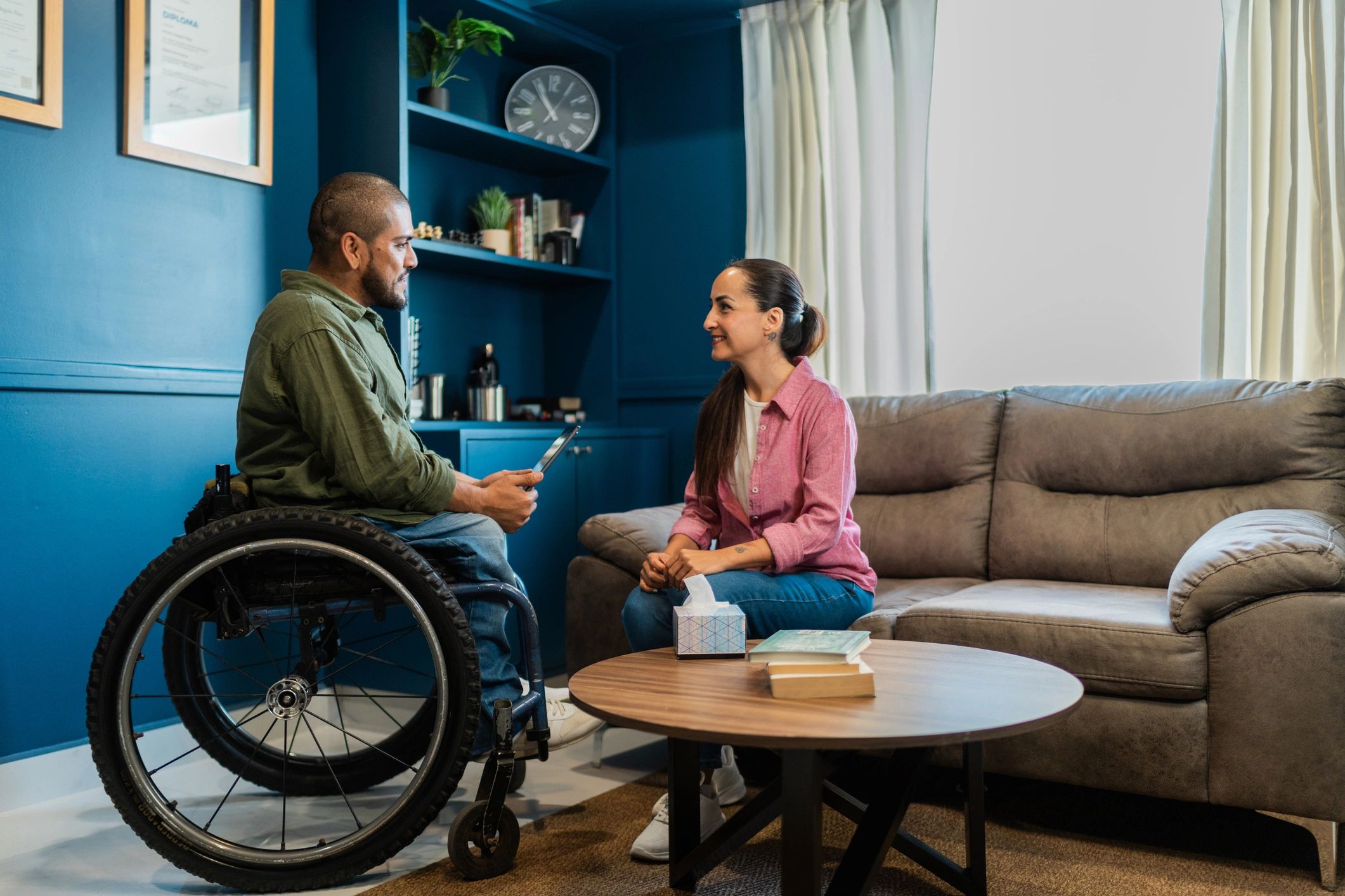 Wheelchair-using therapist speaking with a participant